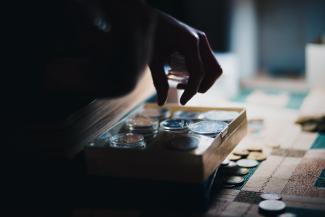 a close up of a person playing a board game by Yuri Krupenin courtesy of Unsplash.